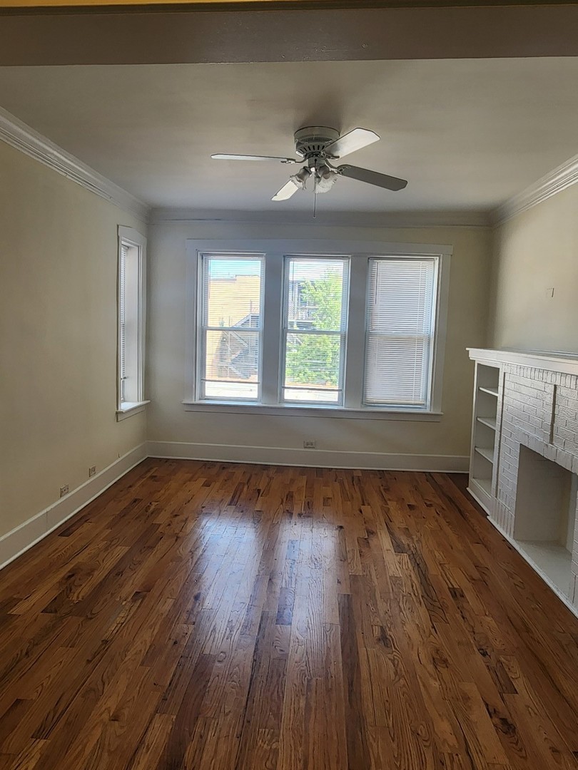3219 West Division Street, Unit 2N Chicago, IL 60651 - Photo 3 of 14 a view of an empty room with wooden floor and a window