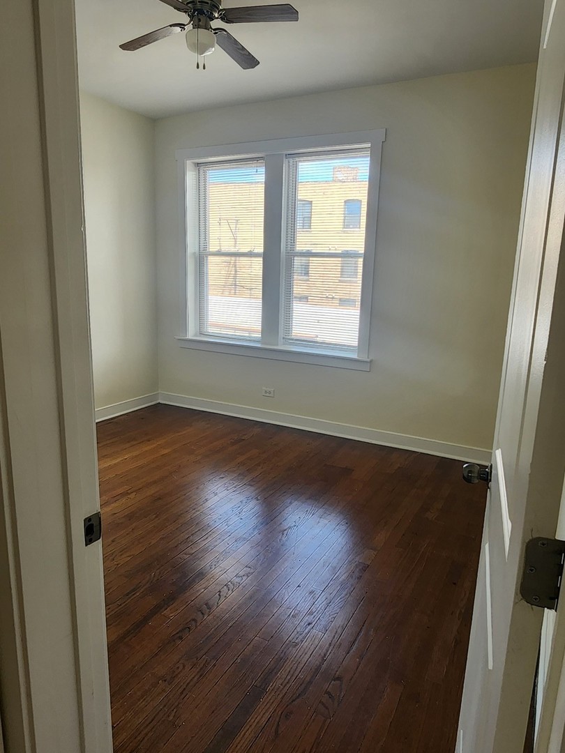 3219 West Division Street, Unit 2N Chicago, IL 60651 - Photo 8 of 14 a view of wooden floor and windows in a room