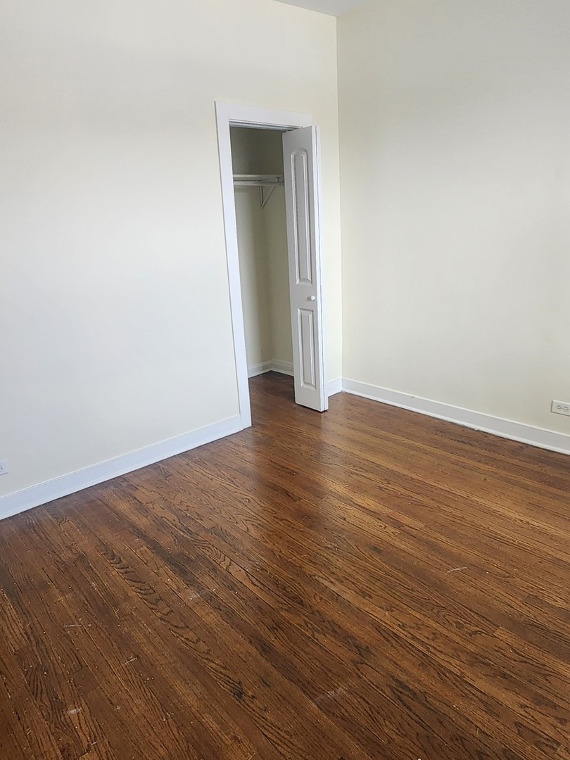 3219 West Division Street, Unit 2N Chicago, IL 60651 - Photo 9 of 14 a view of an empty room with wooden floor and closet