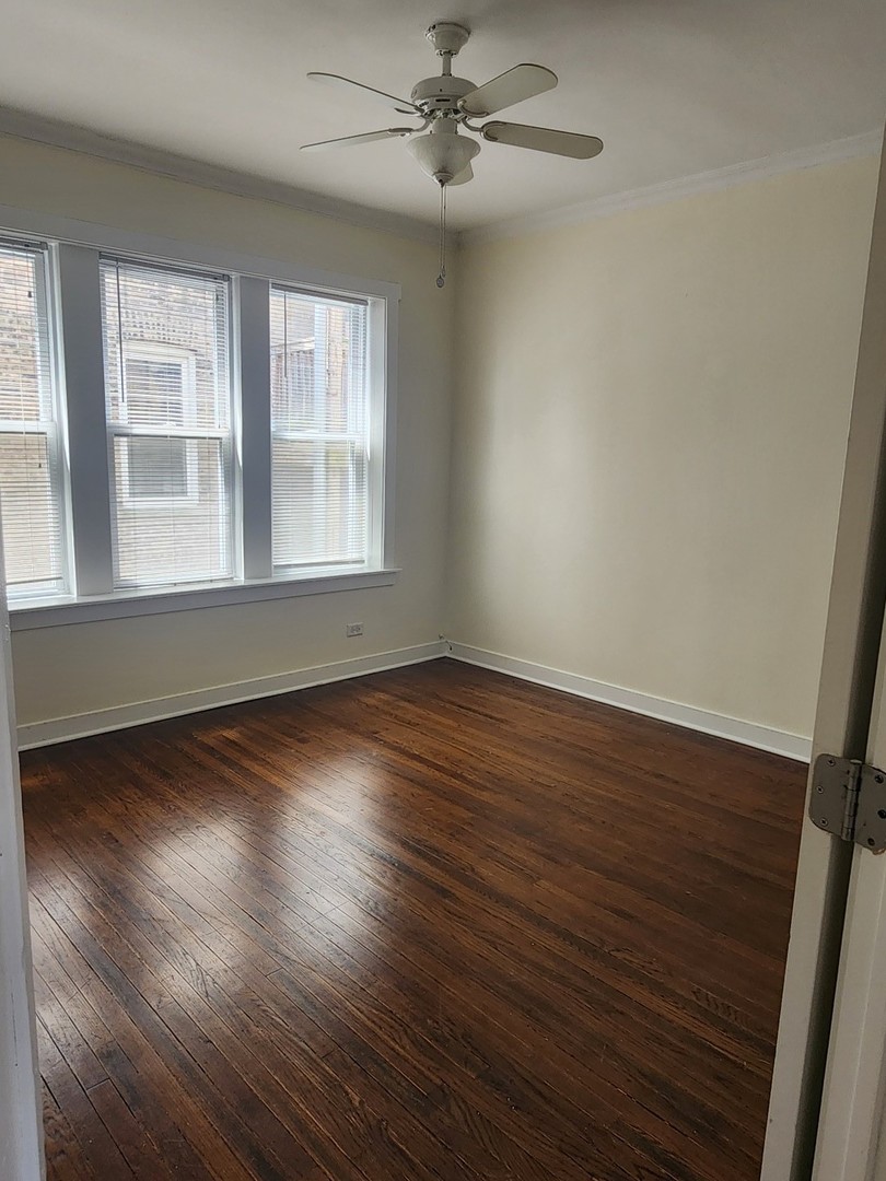 3219 West Division Street, Unit 2N Chicago, IL 60651 - Photo 10 of 14 wooden floor in an empty room with a window