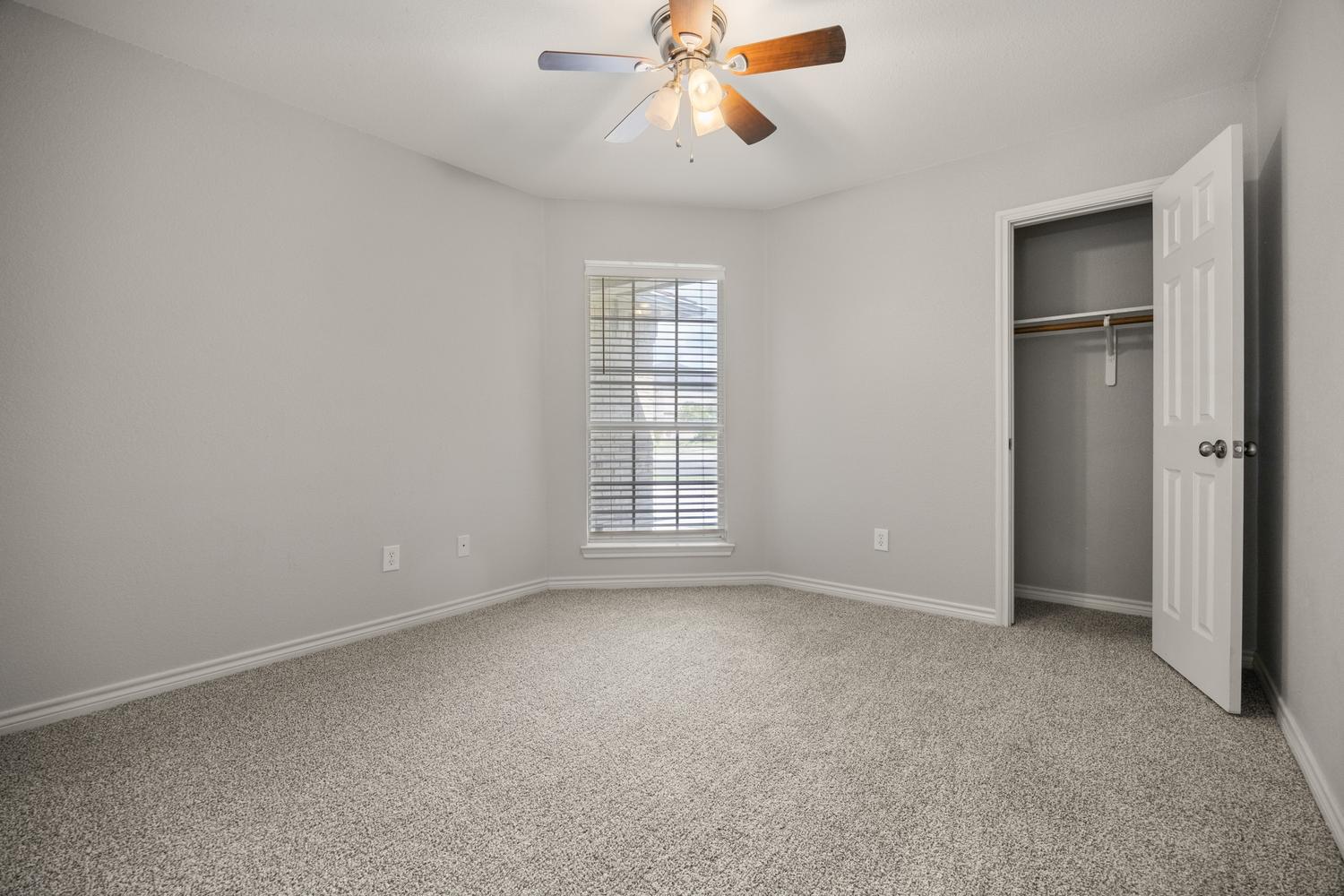 521 Britni Loop Kyle, TX 78640 - Photo 14 of 23 an empty room with windows and fan