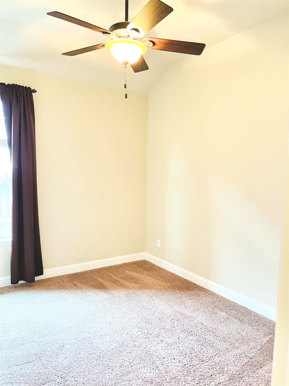 3430 Smart Sands Lane Fulshear, TX 77441 - Photo 11 of 25 an empty room with a ceiling fan and a window