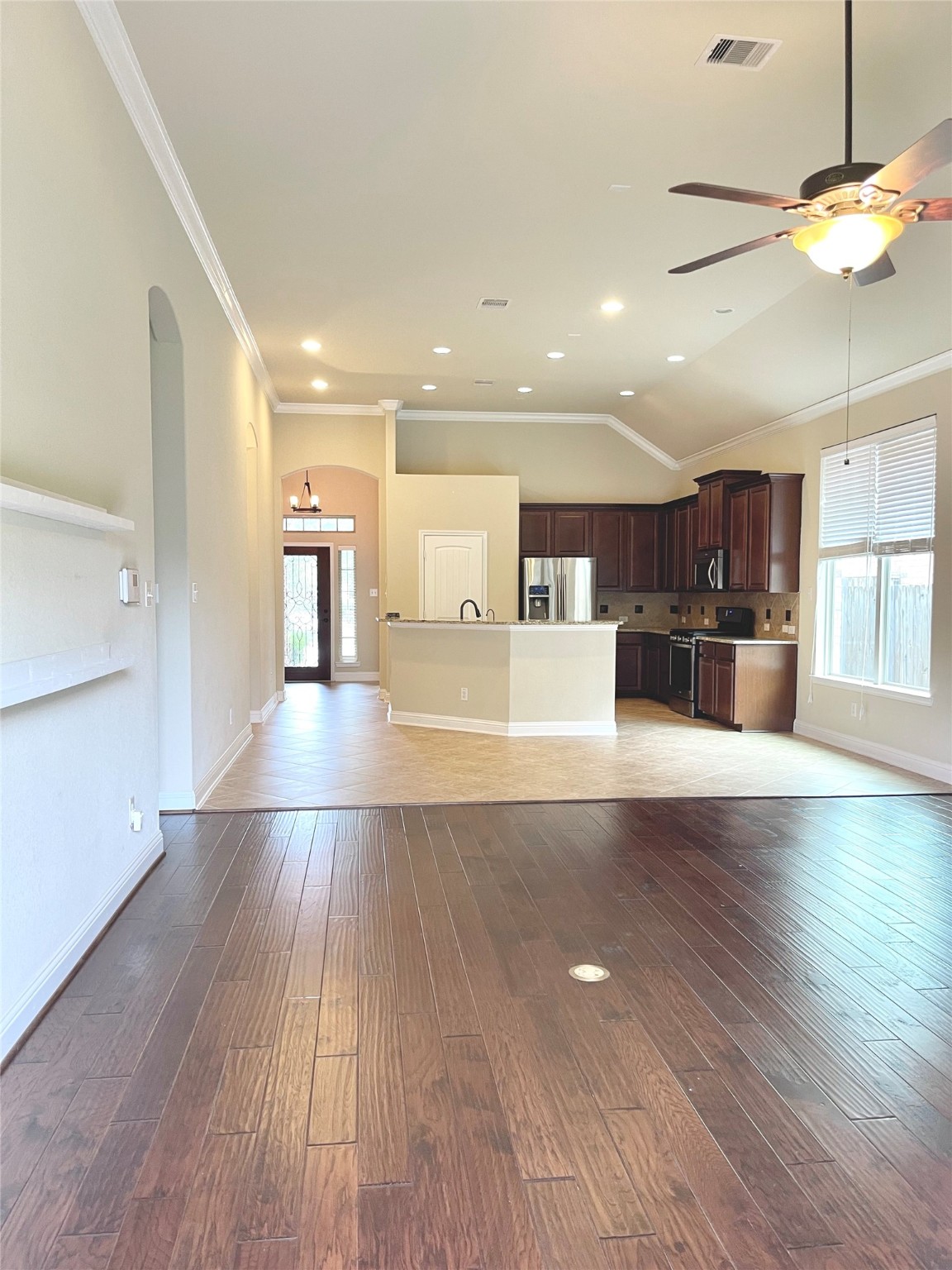 3430 Smart Sands Lane Fulshear, TX 77441 - Photo 25 of 25 a view of a kitchen with kitchen island a sink wooden floor and stainless steel appliances