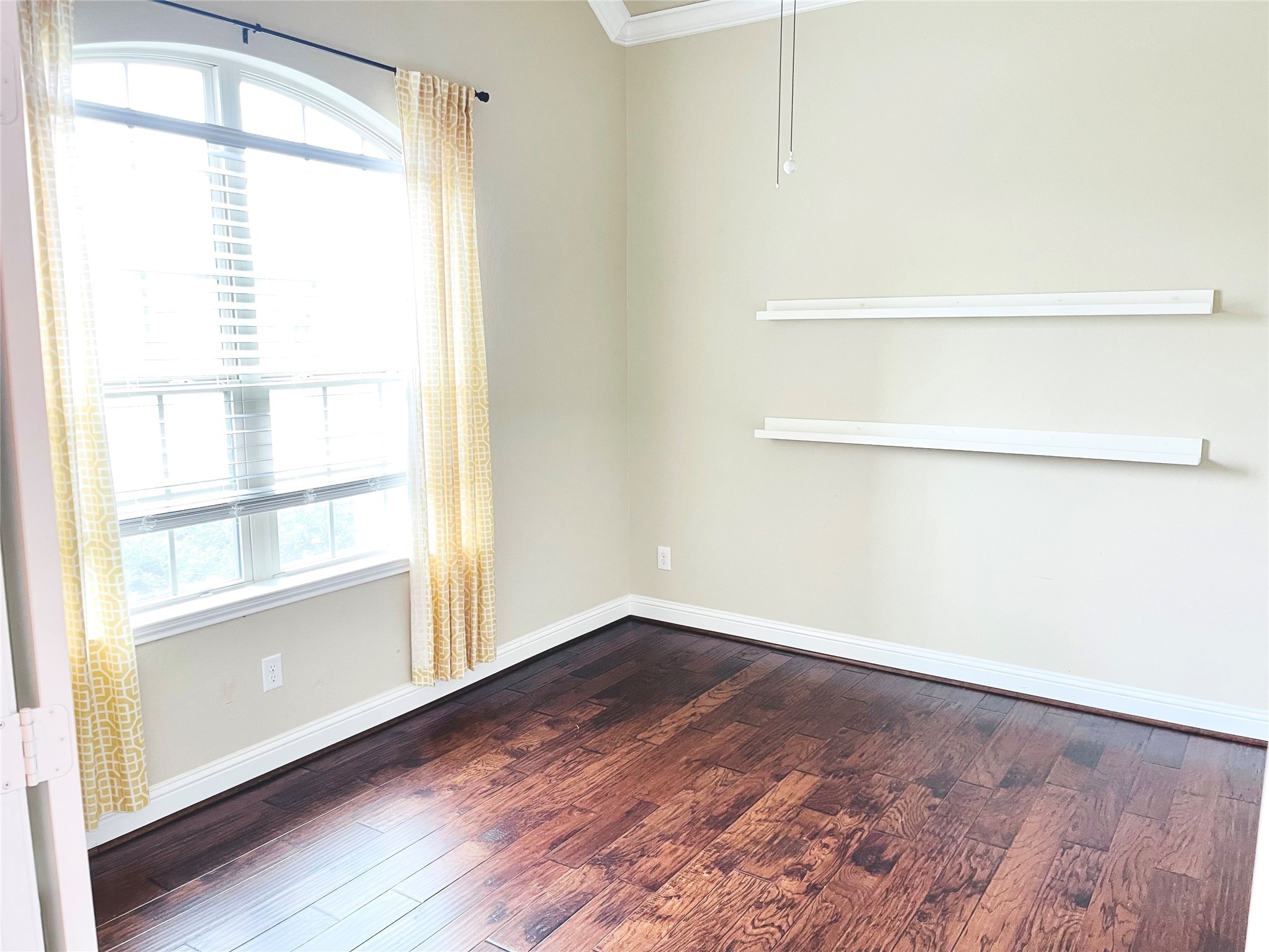 3430 Smart Sands Lane Fulshear, TX 77441 - Photo 5 of 25 a view of an empty room with a window and wooden floor