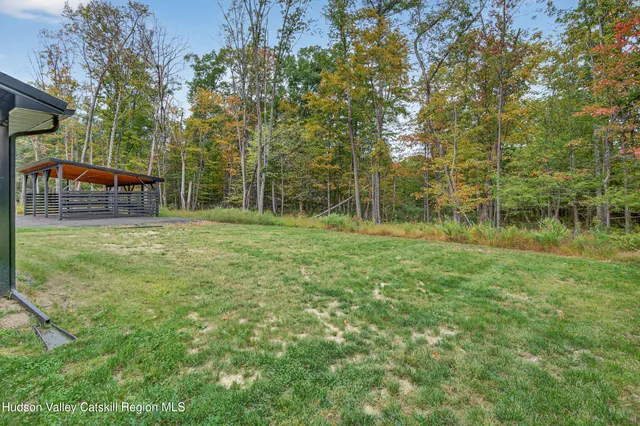 a view of a house with a backyard