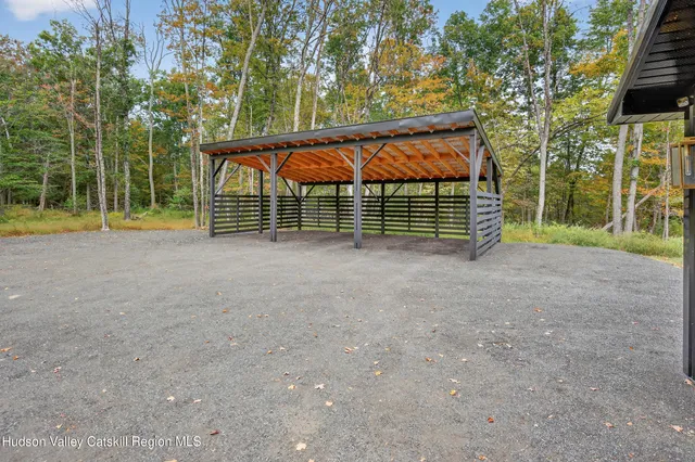 a view of a house with a yard and potted plants