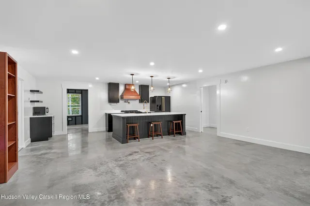 a view of kitchen with refrigerator and window