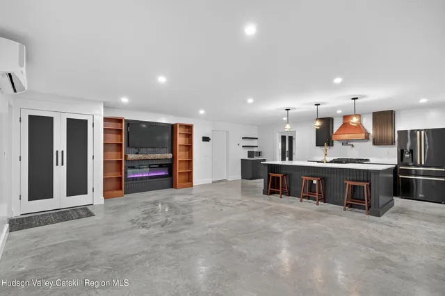 a view of kitchen with stainless steel appliances granite countertop a stove and a refrigerator