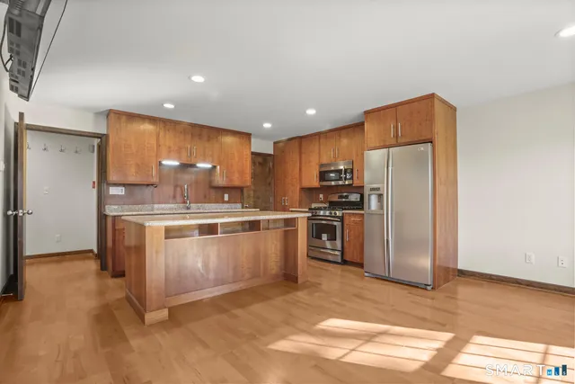 a kitchen with a refrigerator sink and microwave