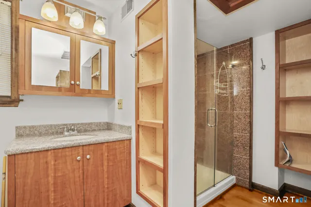 a view of a bathroom with a sink and a mirror