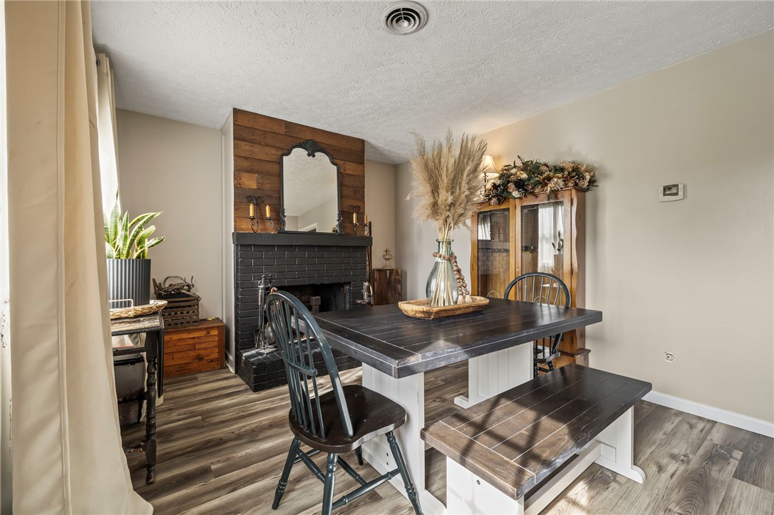 8969 Franklin-Trenton Road Franklin, OH 45005 - Photo 38 of 49 This inviting dining area features elegant wood flooring and a cozy fireplace, perfect for intimate gatherings.