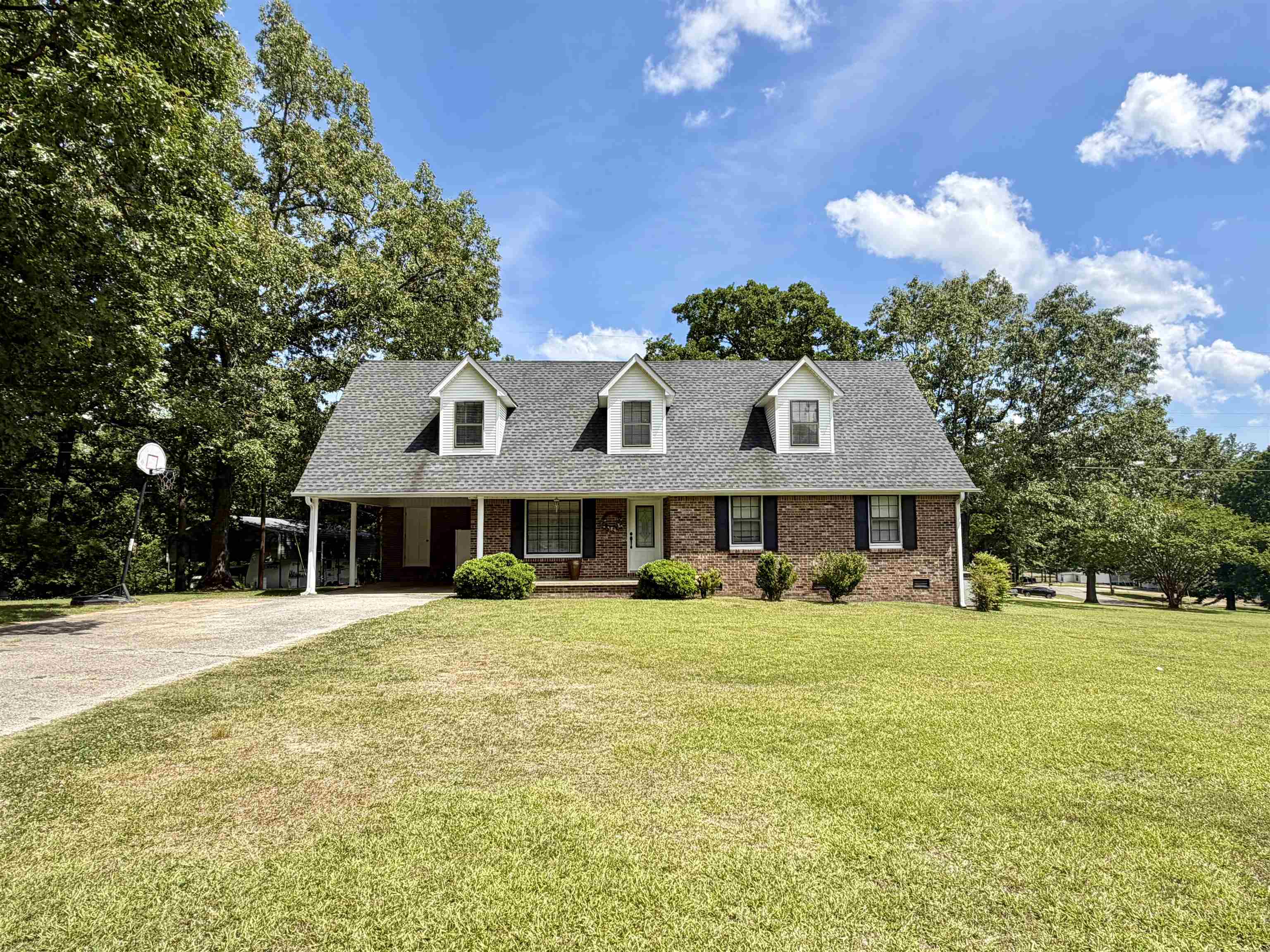 142 Treece Street Selmer, TN 38375 - Photo 32 of 36 Brick facade residence with a gabled roofline and three dormer windows