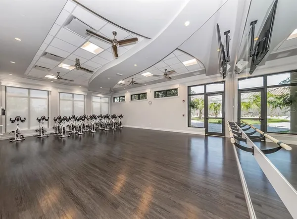 a view of a room with lots of wooden floor and a chandelier