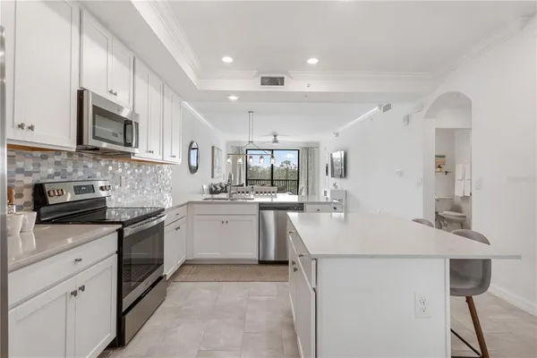 a kitchen with counter top space cabinets and stainless steel appliances