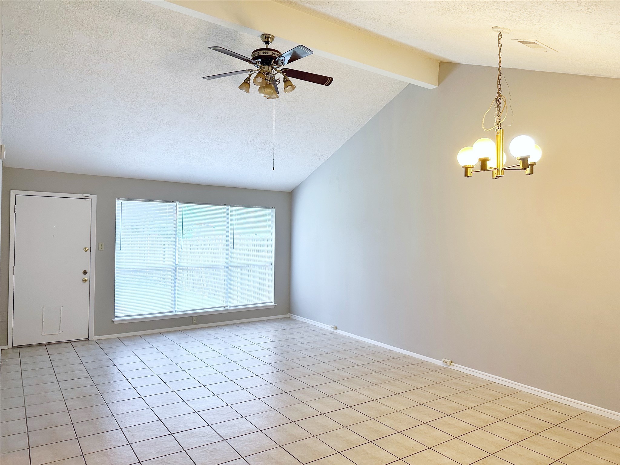 2402 Spring Dusk Drive Spring, TX 77373 - Photo 4 of 8 an empty room with chandelier fan and windows