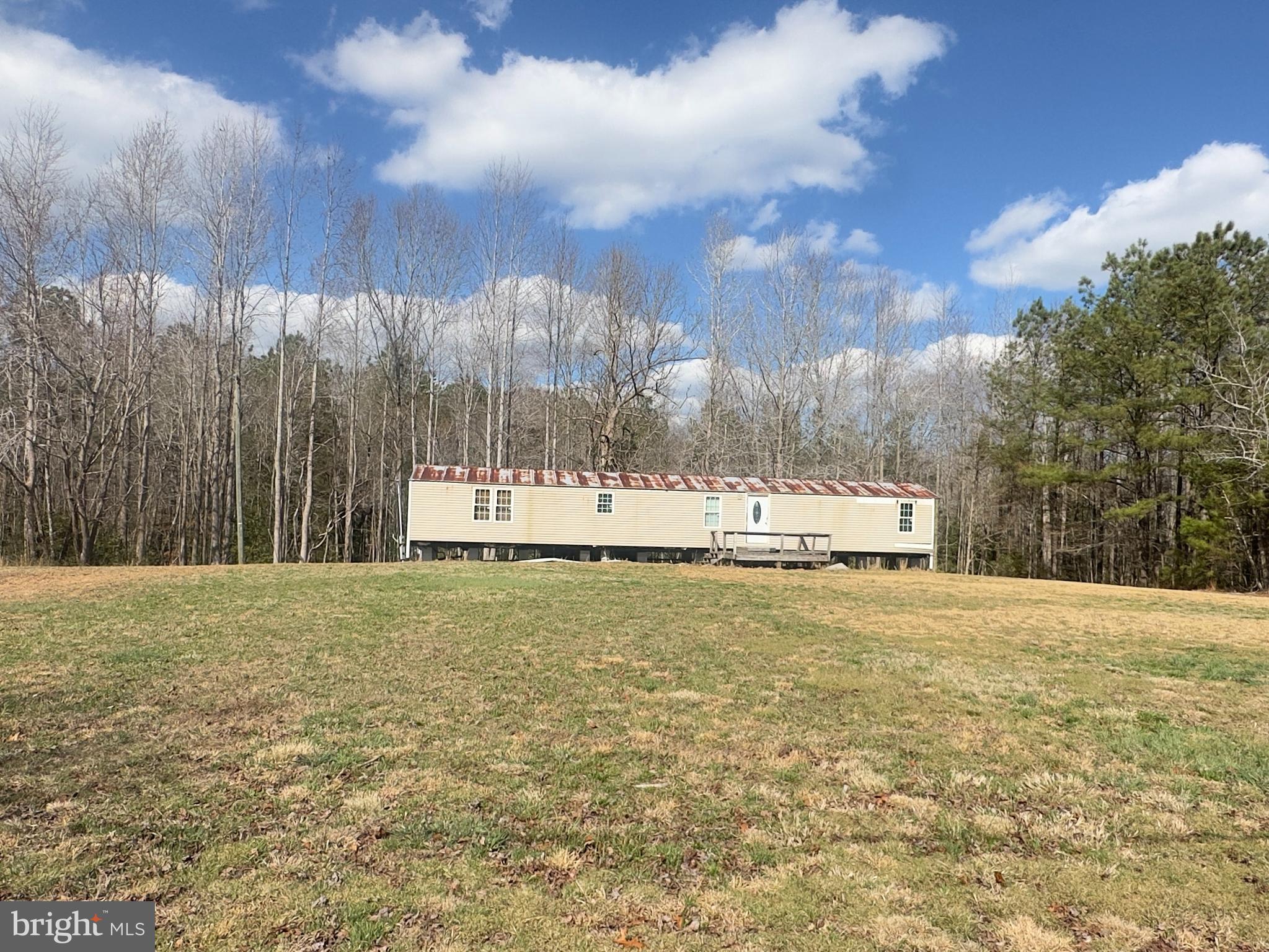 7833 Courthouse Road Heathsville, VA 22473 - Photo 10 of 18 a white house with trees in front of it