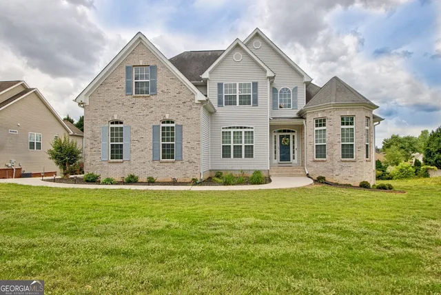 a front view of a house with a yard