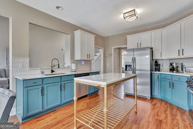 a bathroom with a granite countertop sink toilet a mirror and shower