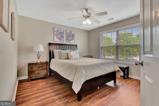 a bedroom with furniture and a flat screen tv