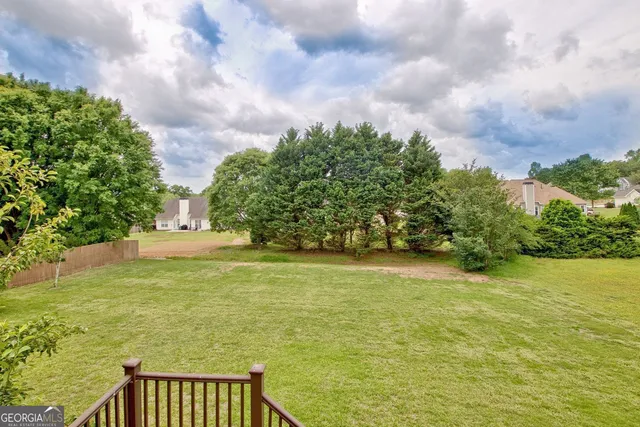 a view of a house with backyard and a sitting area