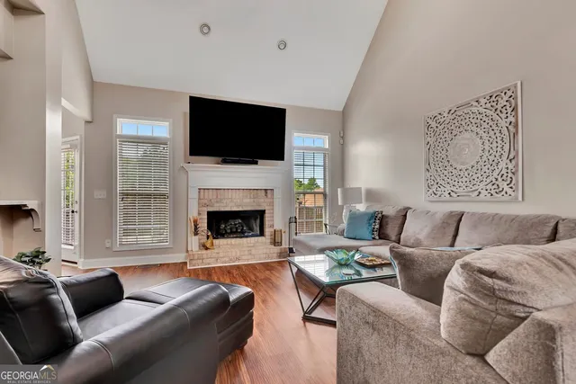 a living room with furniture fireplace and flat screen tv