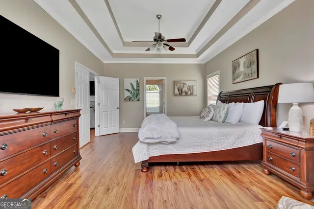 a bedroom with furniture and wooden floor
