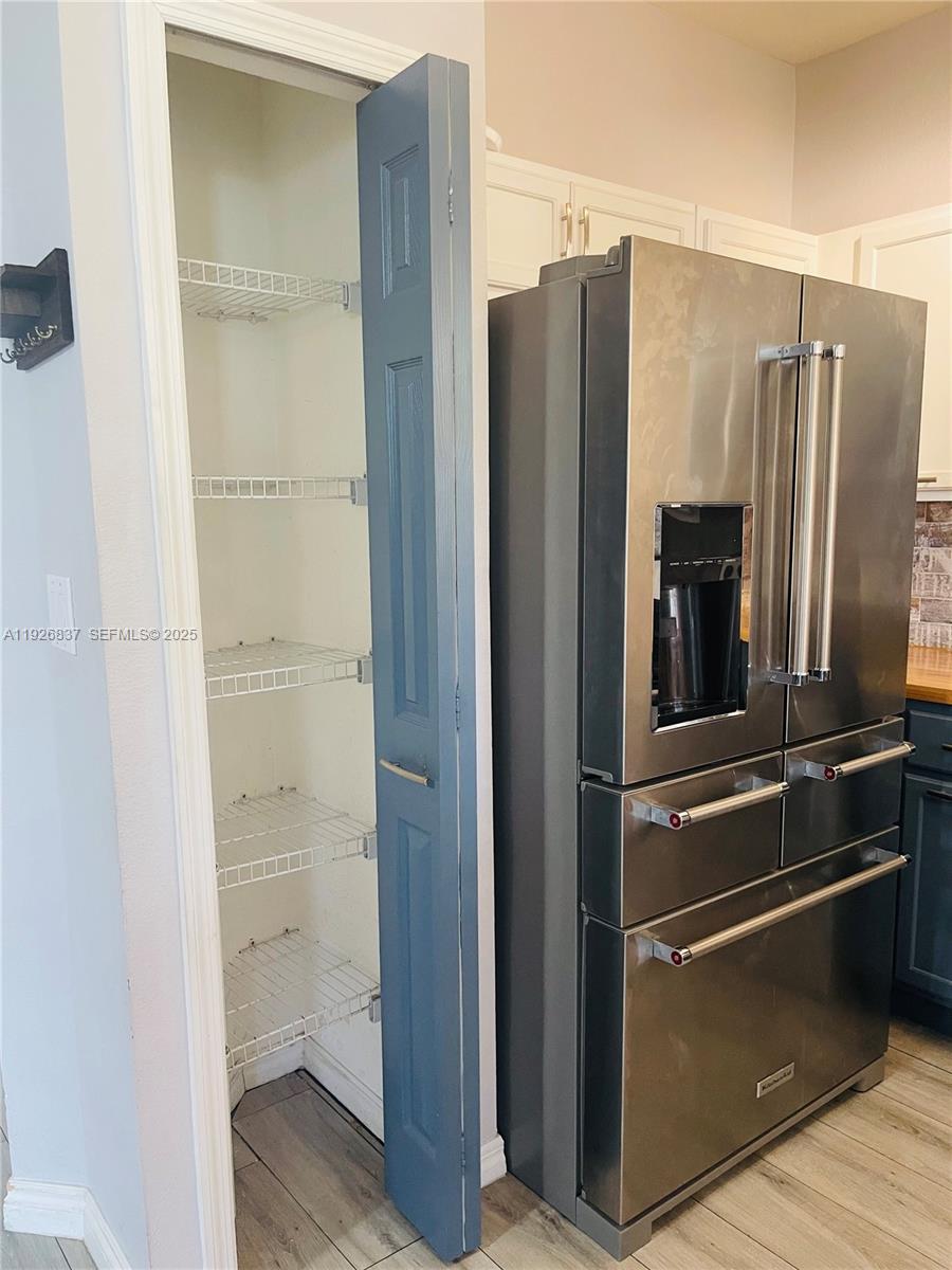 27312 Southwest 138th Path Homestead, FL 33032 - Photo 12 of 41 a view of a refrigerator in kitchen and a glass door