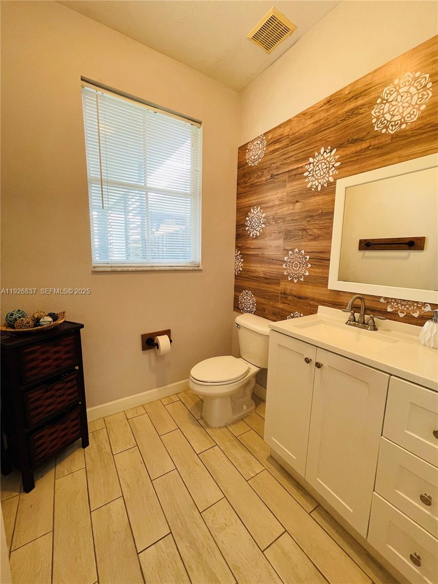 27312 Southwest 138th Path Homestead, FL 33032 - Photo 16 of 41 a bathroom with a sink a toilet and mirror