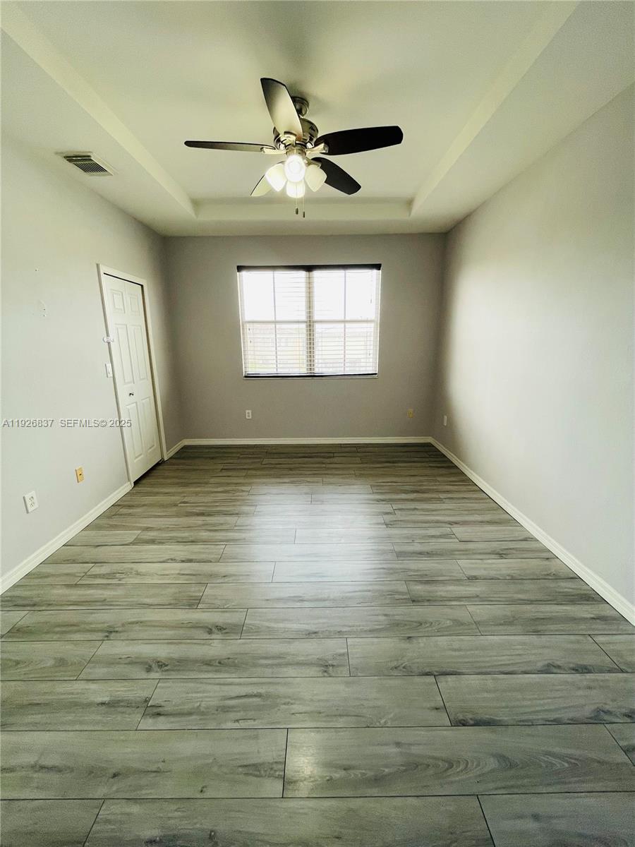 27312 Southwest 138th Path Homestead, FL 33032 - Photo 20 of 41 a view of empty room with wooden floor and fan
