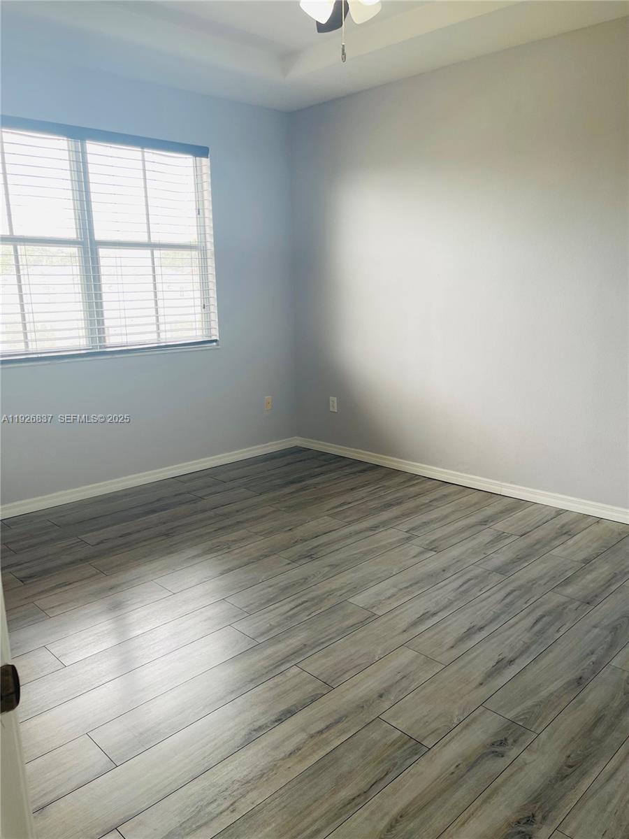 27312 Southwest 138th Path Homestead, FL 33032 - Photo 21 of 41 wooden floor in an empty room with a window