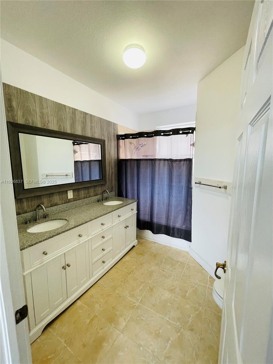 27312 Southwest 138th Path Homestead, FL 33032 - Photo 23 of 41 a kitchen with sink cabinets and stove