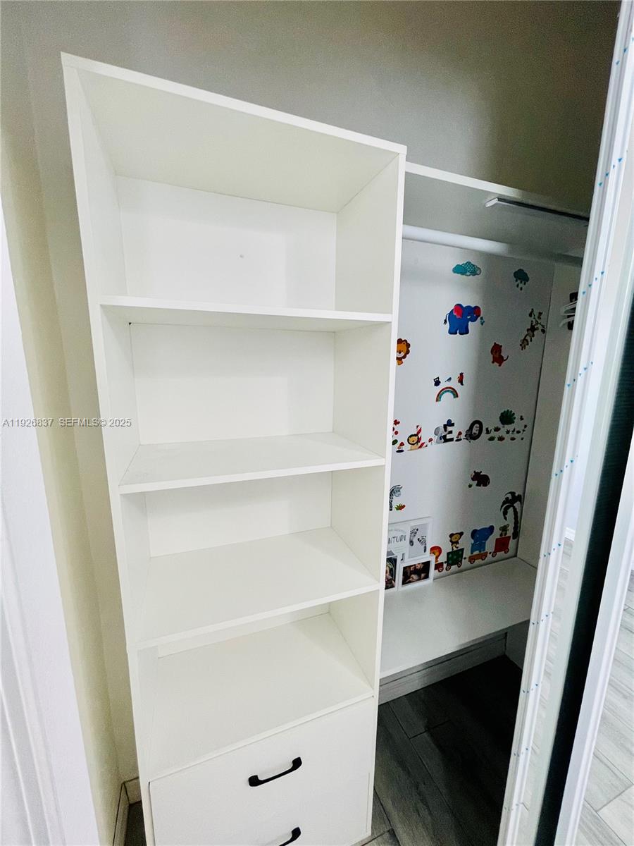 27312 Southwest 138th Path Homestead, FL 33032 - Photo 28 of 41 a view of walk in closet with empty racks