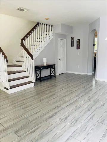 a view of entryway with wooden floor and stairs