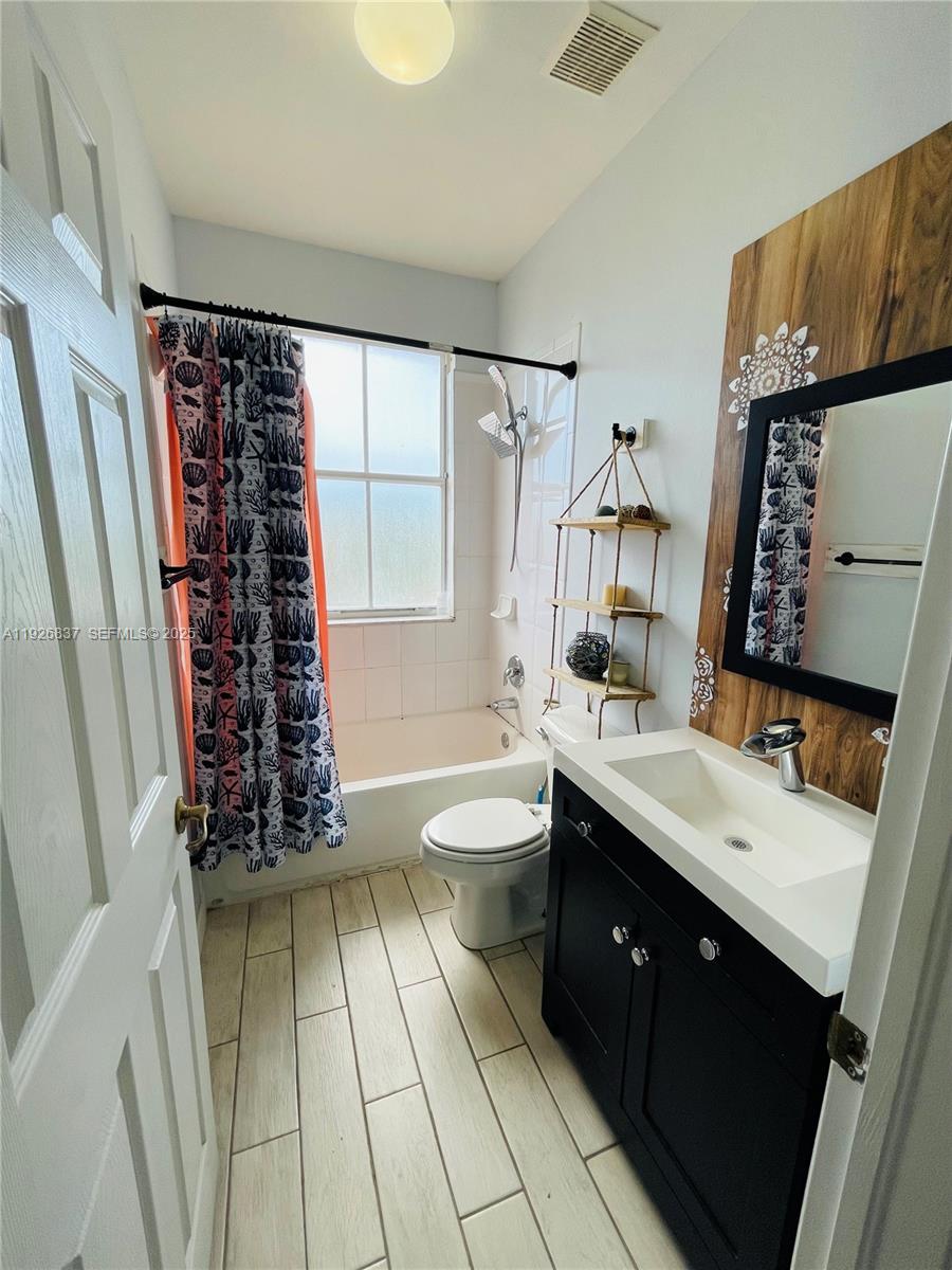 27312 Southwest 138th Path Homestead, FL 33032 - Photo 35 of 41 a spacious bathroom with a double vanity sink toilet mirror and tub