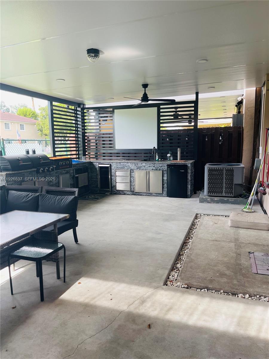 27312 Southwest 138th Path Homestead, FL 33032 - Photo 36 of 41 a living room with furniture and a flat screen tv