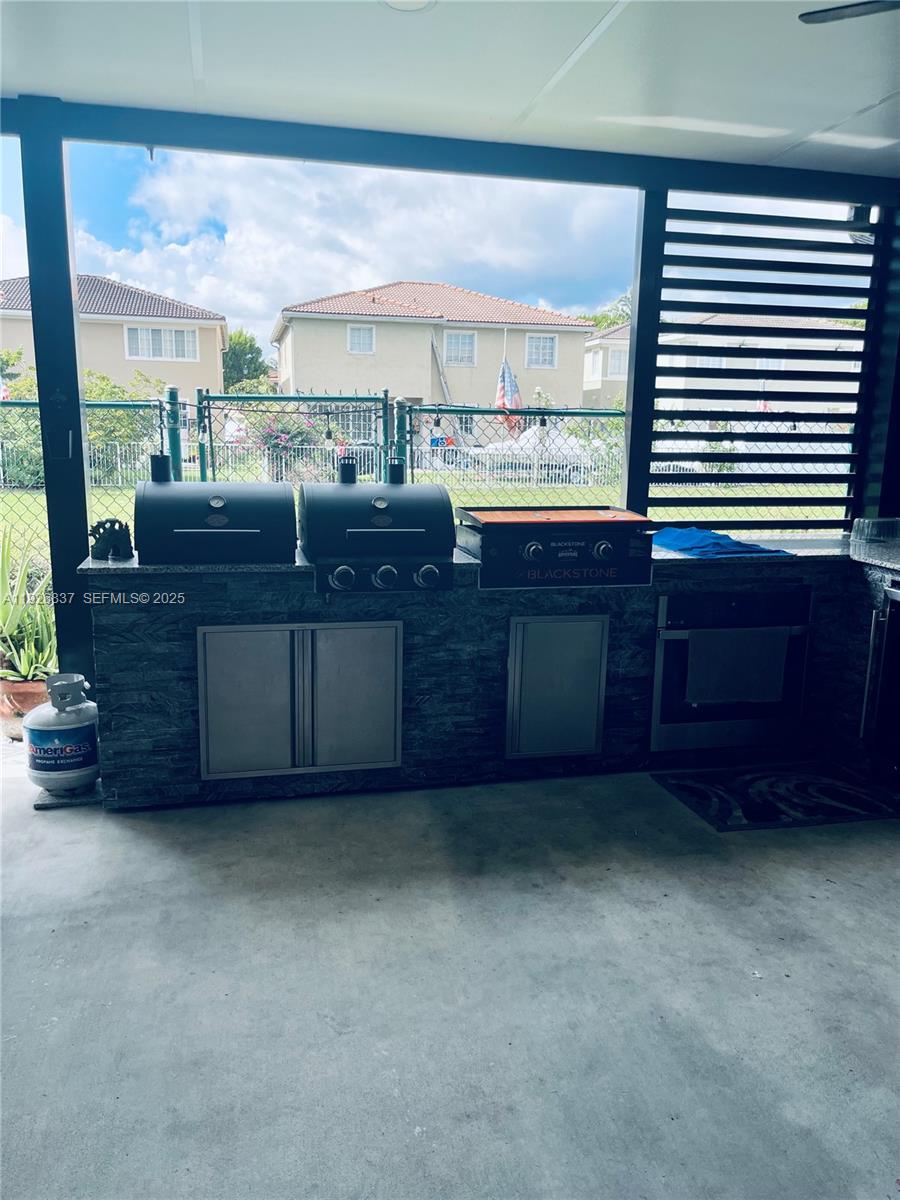 27312 Southwest 138th Path Homestead, FL 33032 - Photo 39 of 41 a room with lots of wooden furniture and a sink