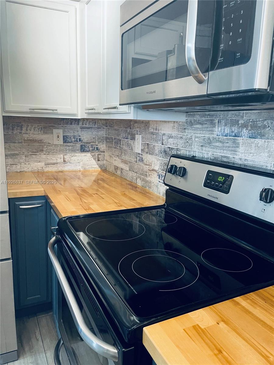 27312 Southwest 138th Path Homestead, FL 33032 - Photo 10 of 41 a kitchen with a stove and a microwave
