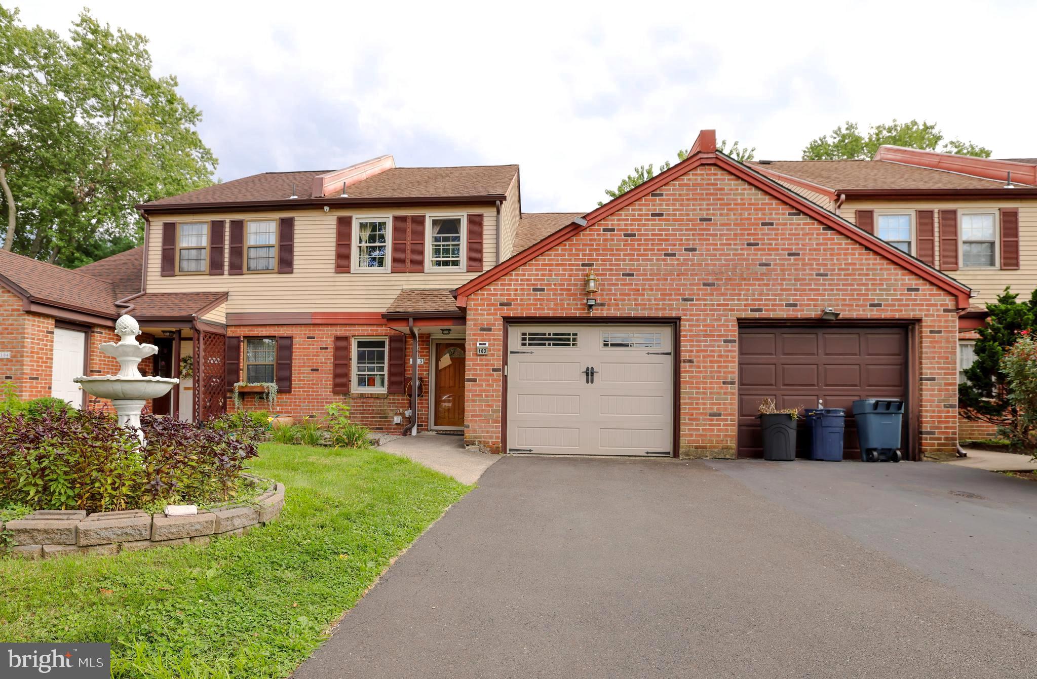 103 Garrison Court Langhorne, PA 19047 - Photo 2 of 46 a front view of a house with a yard and garage