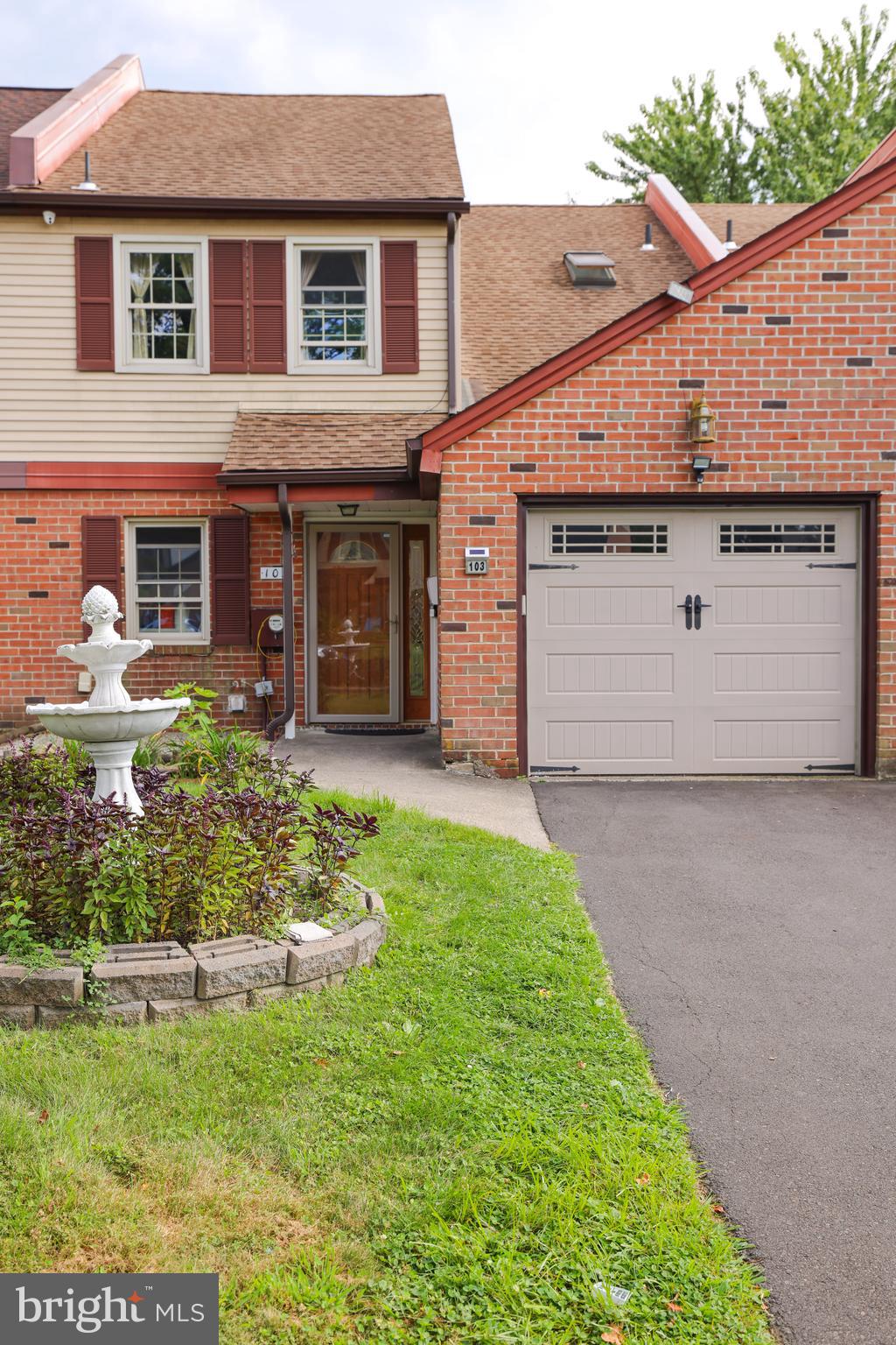 103 Garrison Court Langhorne, PA 19047 - Photo 3 of 46 a front view of a house with a garden and plants
