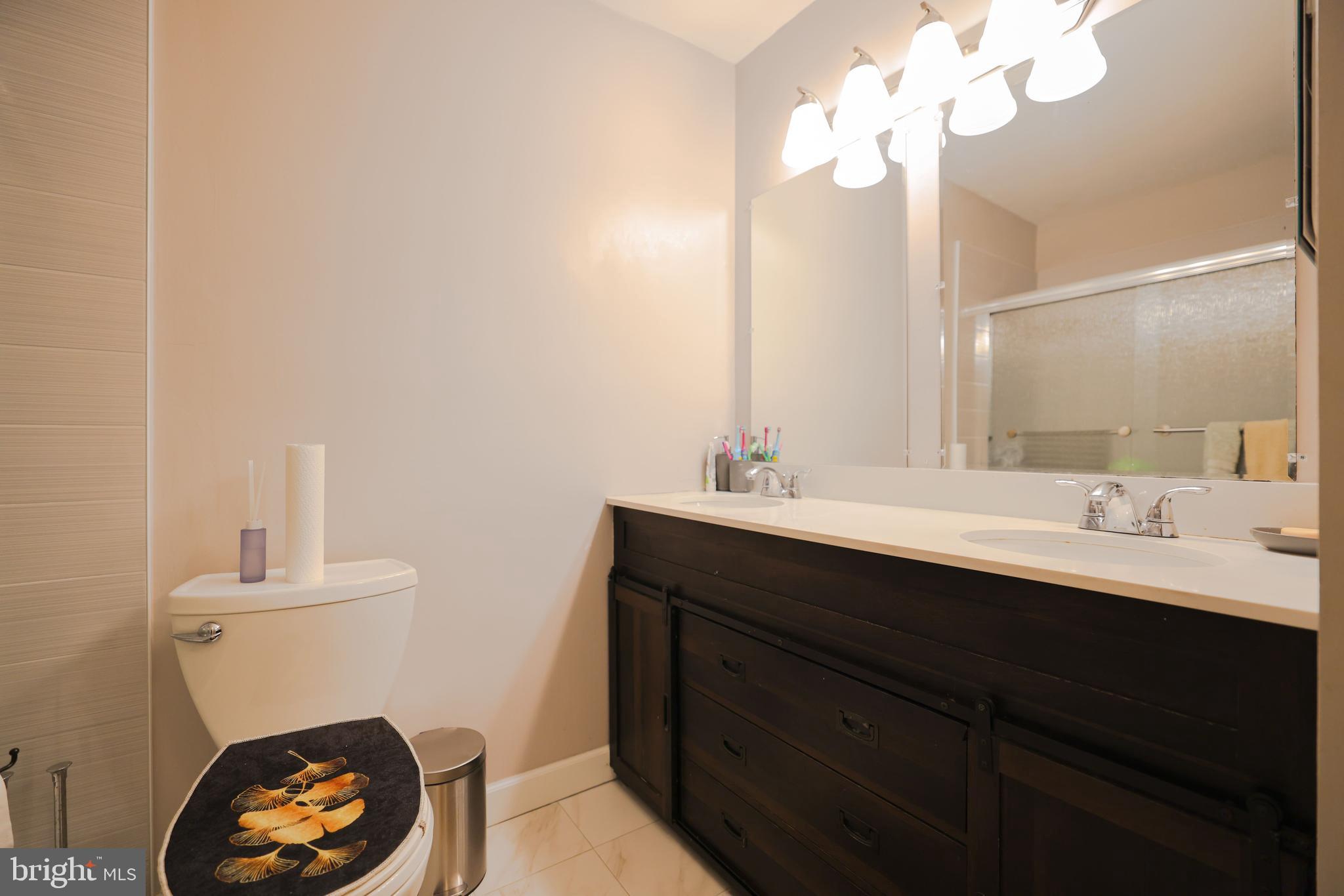 103 Garrison Court Langhorne, PA 19047 - Photo 32 of 46 a bathroom with a sink a light fixture and a toilet