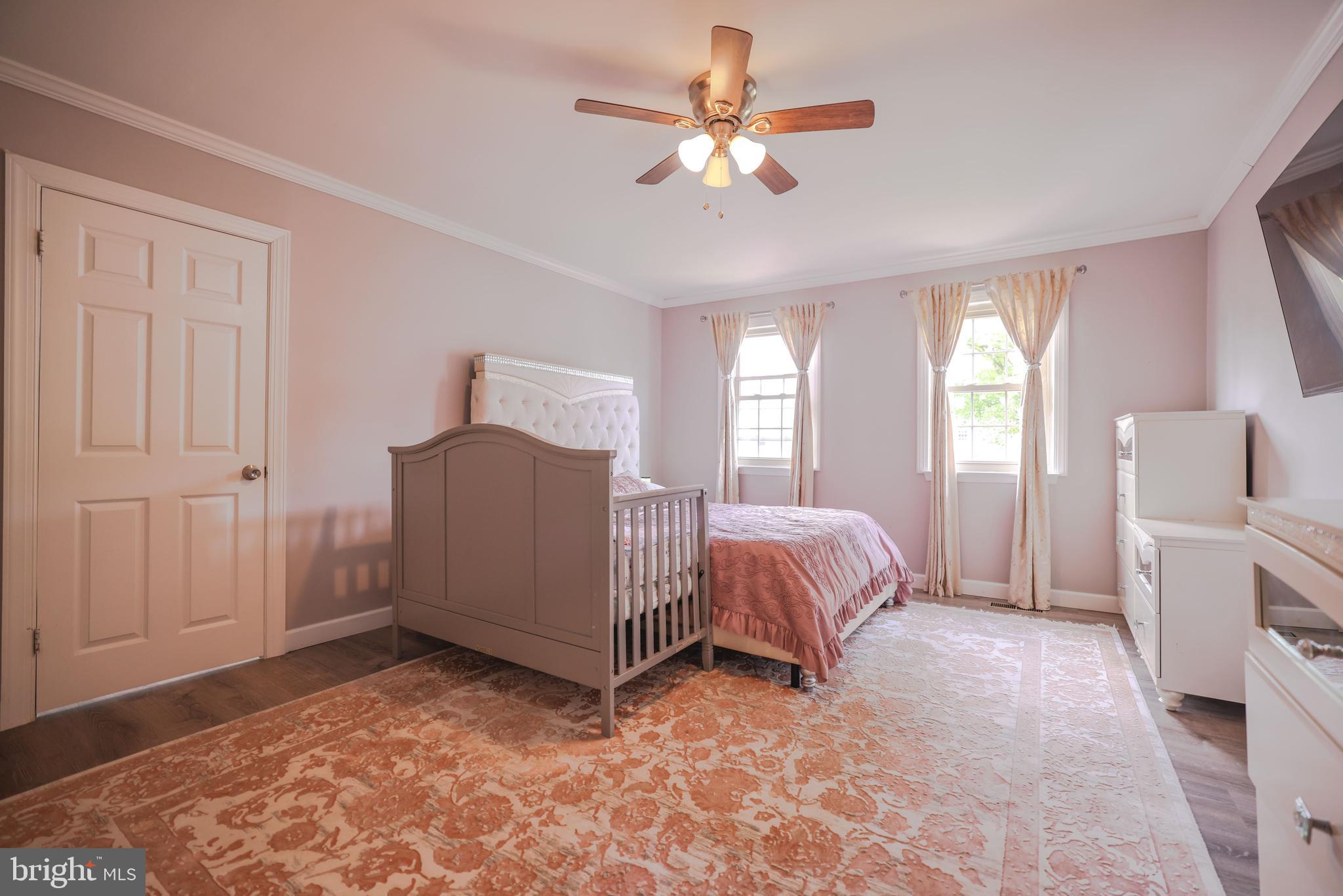 103 Garrison Court Langhorne, PA 19047 - Photo 35 of 46 a spacious bedroom with a bed and a chandelier