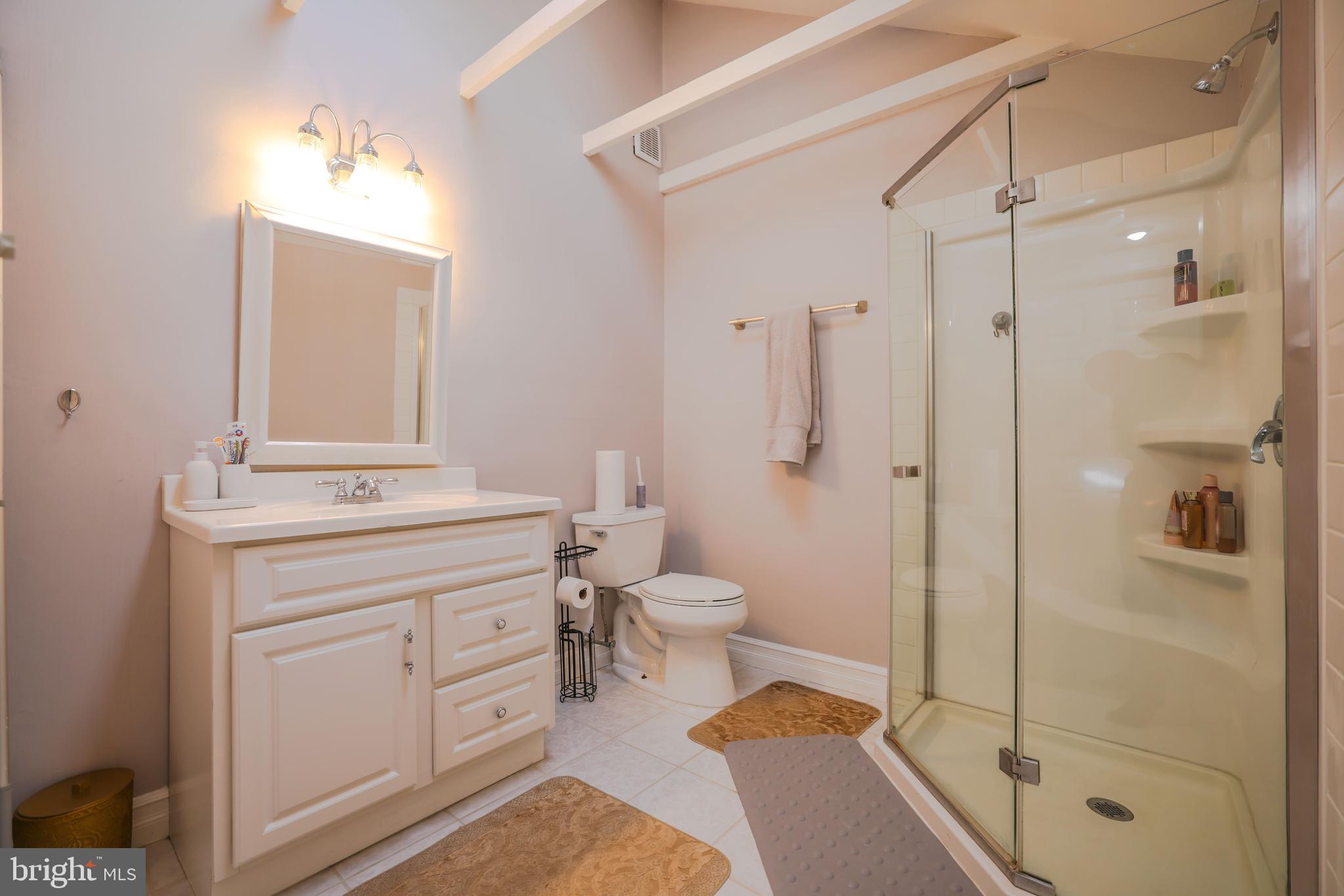 103 Garrison Court Langhorne, PA 19047 - Photo 36 of 46 a bathroom with a shower toilet sink and mirror