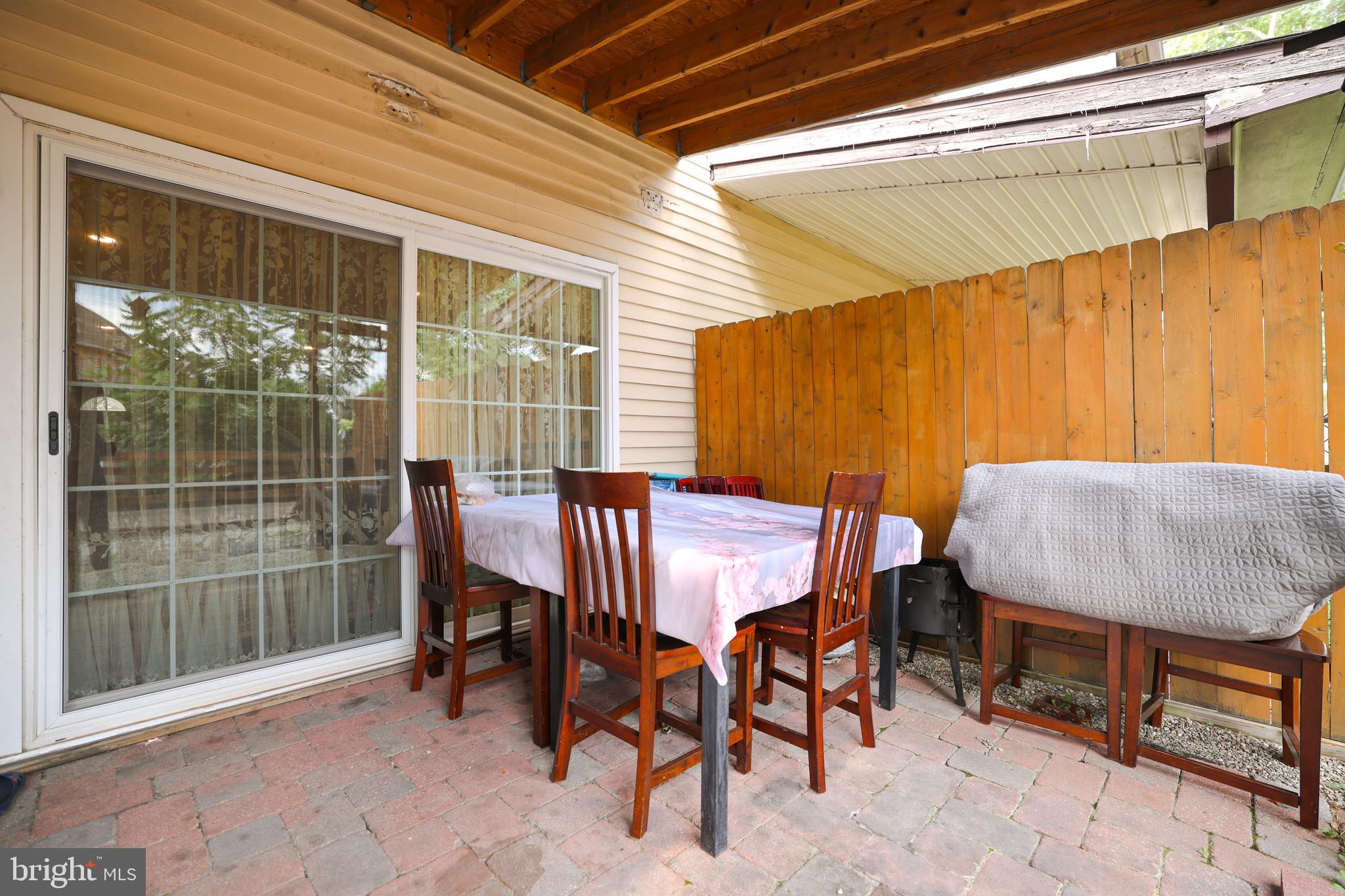 103 Garrison Court Langhorne, PA 19047 - Photo 41 of 46 a view of a patio with table and chairs with wooden floor and fence