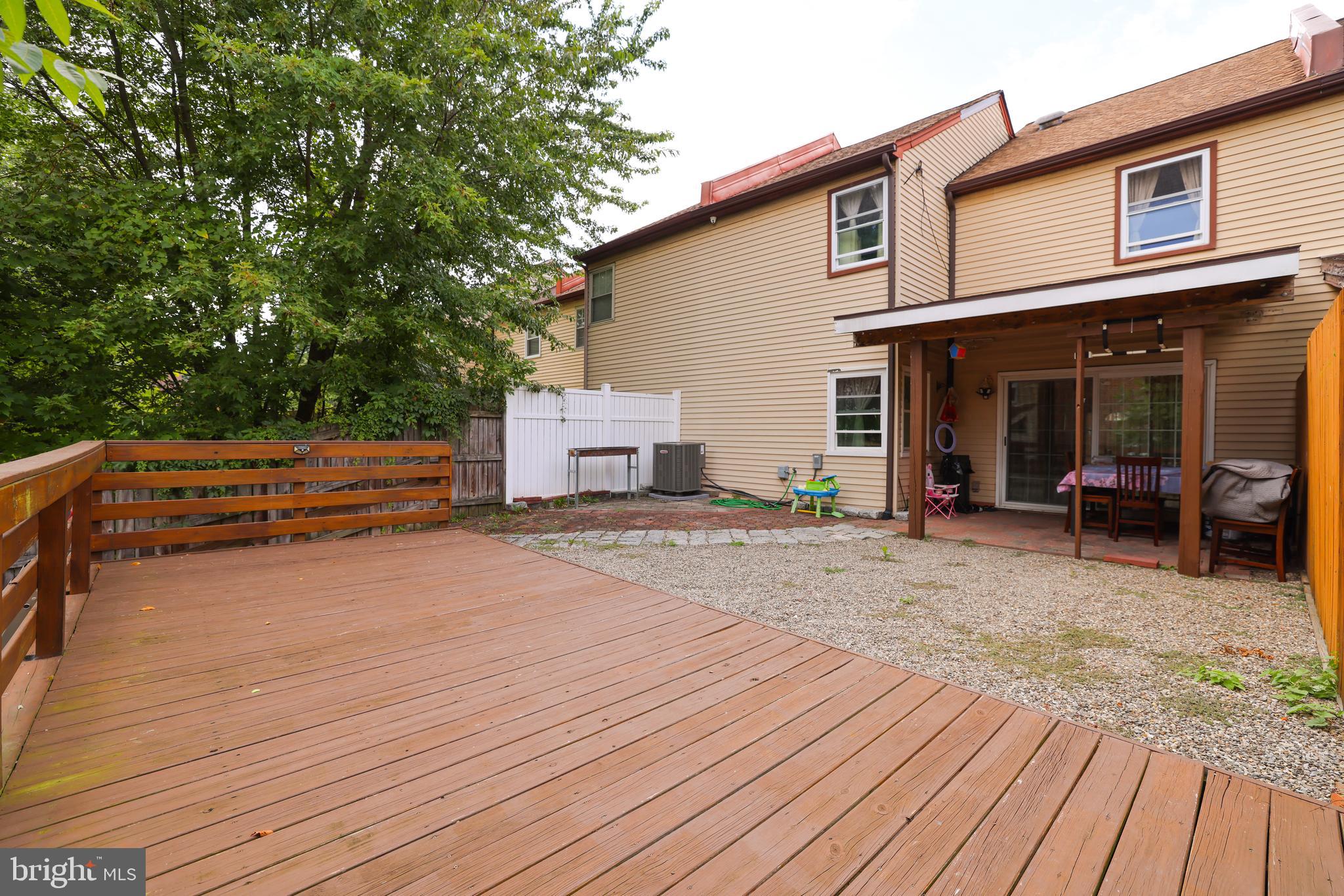 103 Garrison Court Langhorne, PA 19047 - Photo 45 of 46 a backyard of a house with wooden floor and seating space