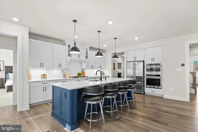a kitchen with granite countertop a sink a counter top space and living room view