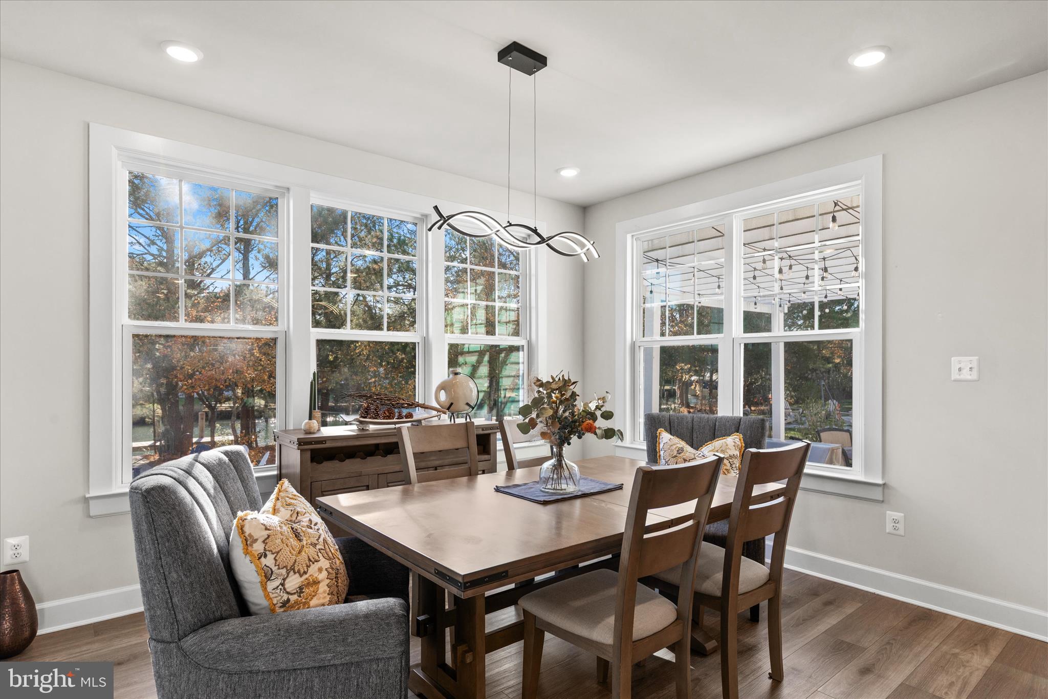 12377 Hidden Bay Drive Berlin, MD 21811 - Photo 18 of 71 a view of a dining room with furniture large windows and wooden floor