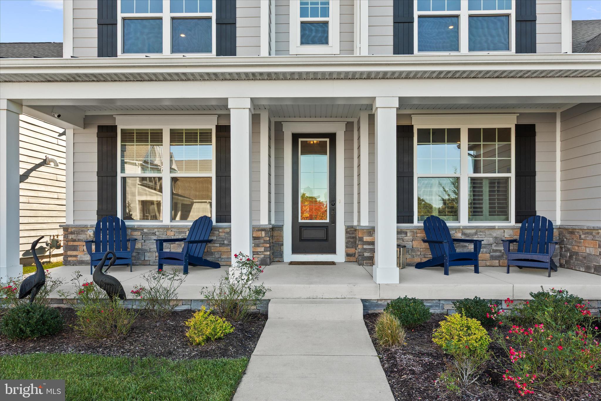 12377 Hidden Bay Drive Berlin, MD 21811 - Photo 3 of 71 a view of a brick house with a chairs and table in a patio