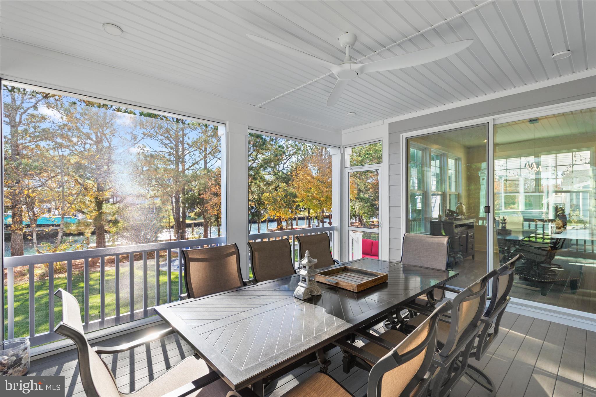12377 Hidden Bay Drive Berlin, MD 21811 - Photo 45 of 71 a view of a dining room with furniture large windows and wooden floor