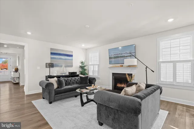a kitchen with stainless steel appliances kitchen island granite countertop a table chairs and wooden cabinets