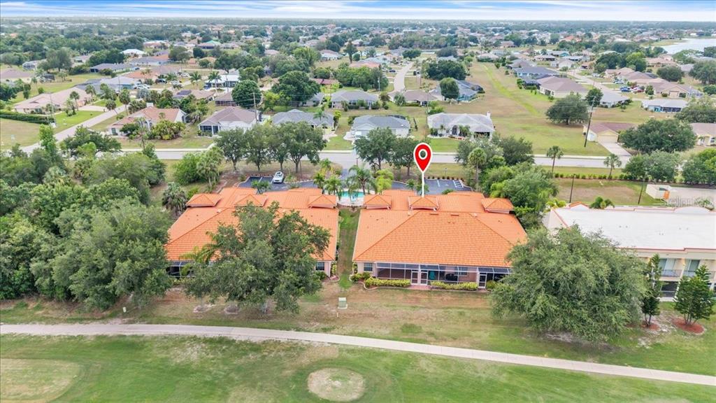 1260 Rio De Janeiro Avenue, Unit 102 Punta Gorda, FL 33983 - Photo 42 of 46 an aerial view of residential houses with outdoor space and trees
